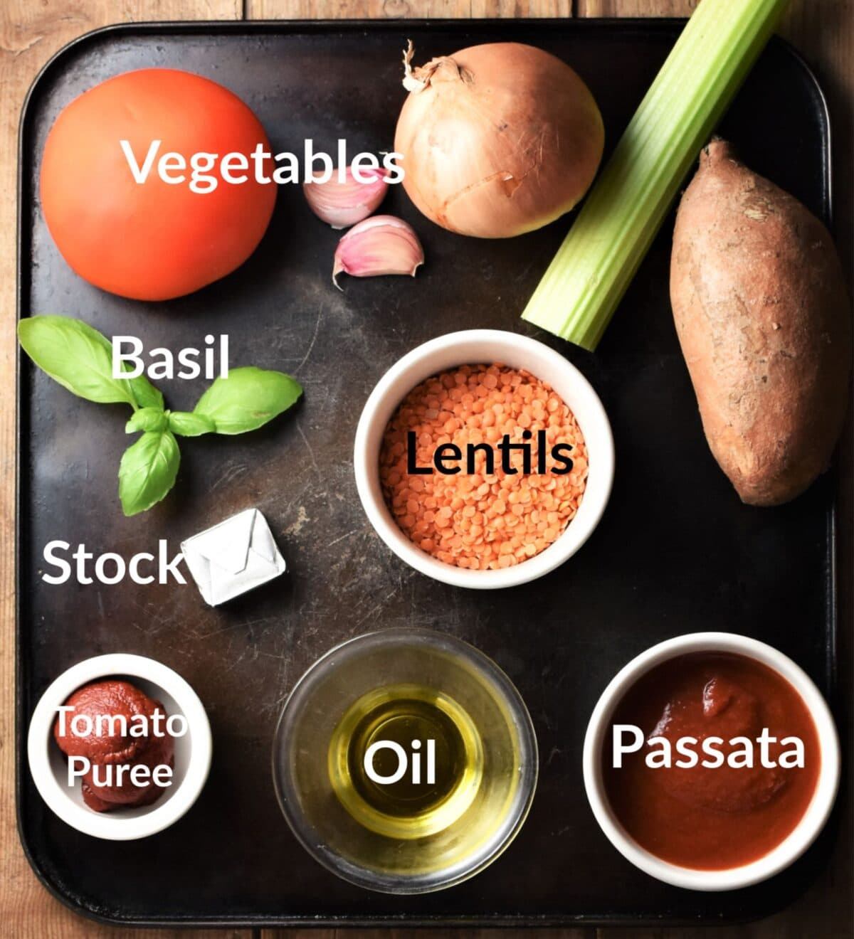 Tomato and lentil soup ingredients in individual dishes.