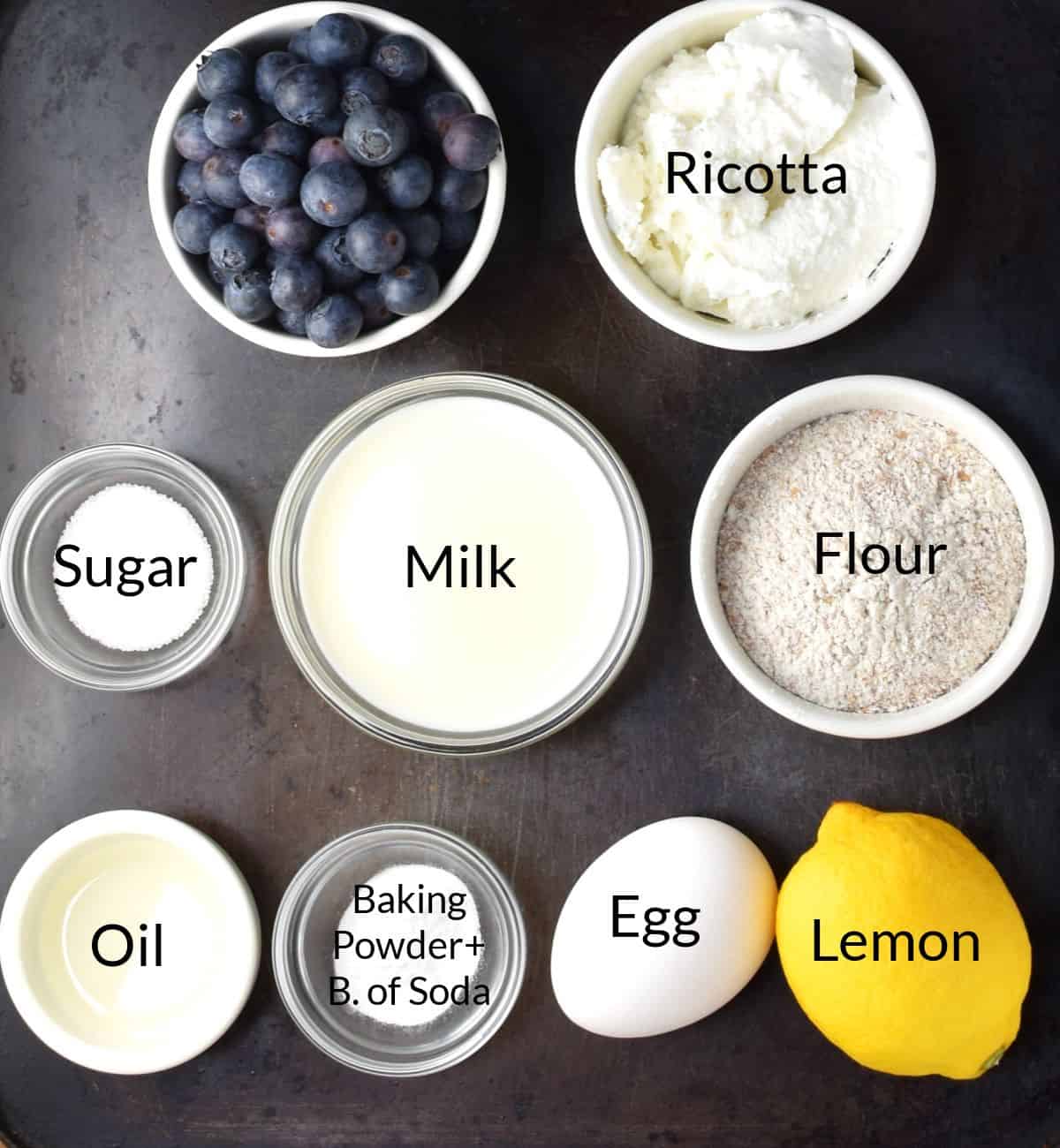 Top down view of ingredients for blueberry lemon ricotta pancakes in individual dishes.