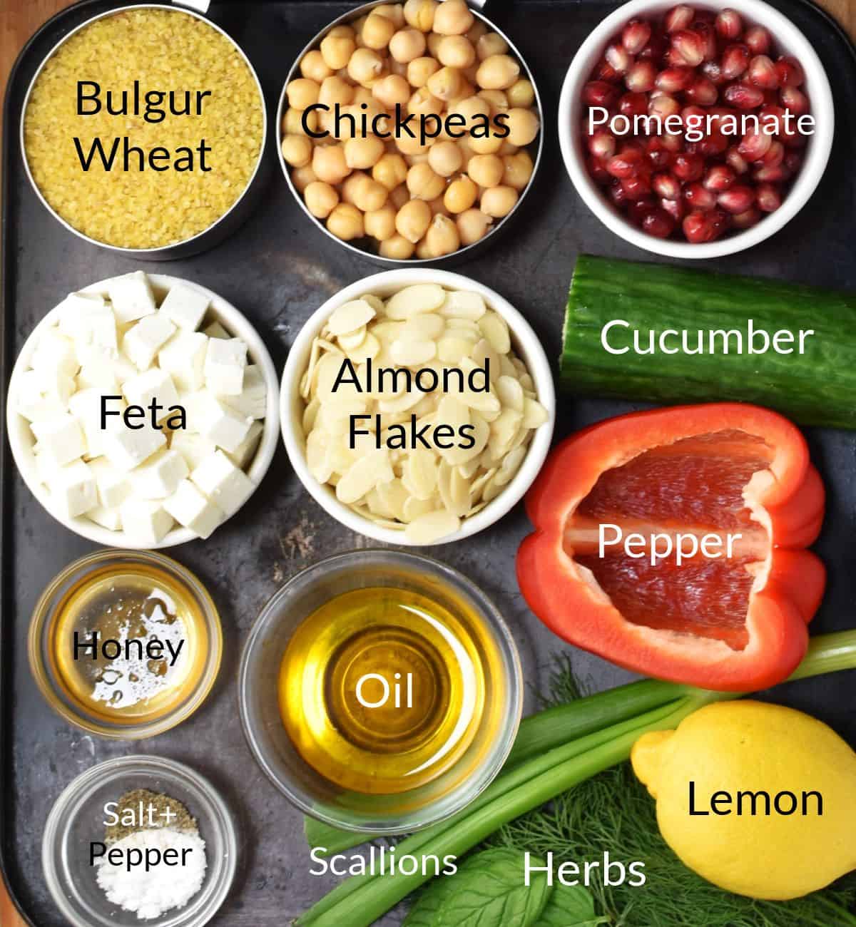 Top down view of ingredients for making bulgur salad in individual dishes.