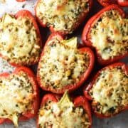 Top down view of baked chickpea stuffed peppers with cheese on top.