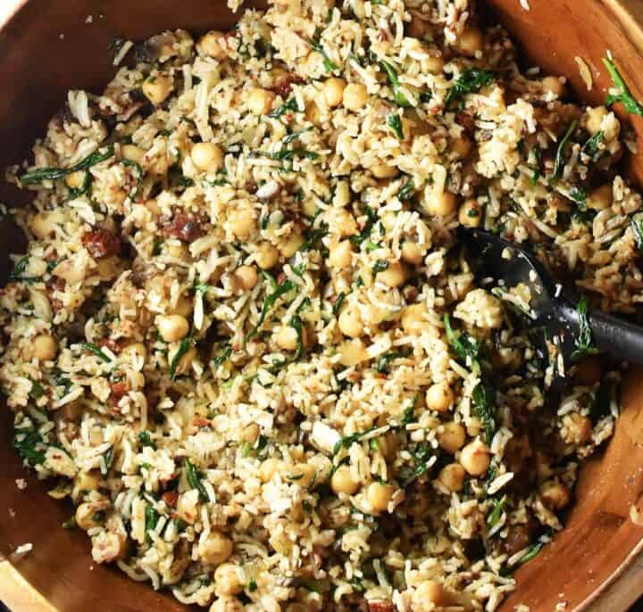 Filling mixture for chickpea stuffed peppers in large wooden bowl.