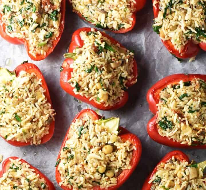 Pepper halves with chickpea stuffing on parchment.