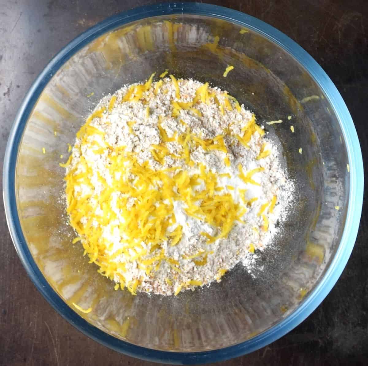 Flour and lemon zest in glass bowl.