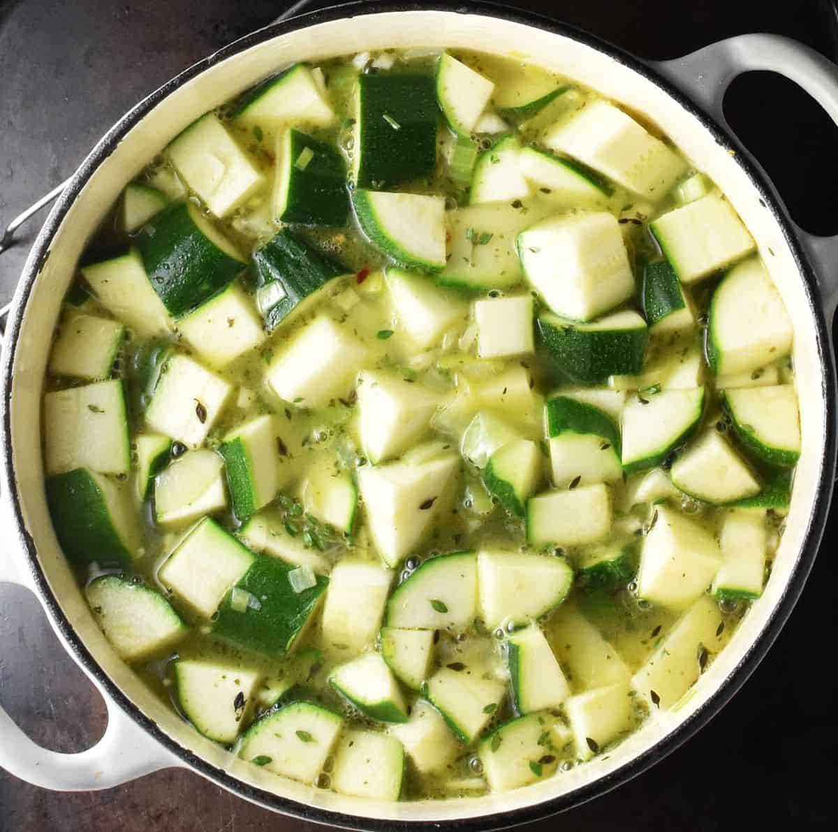 Cubed potatoes and zucchini with stock in large pot.