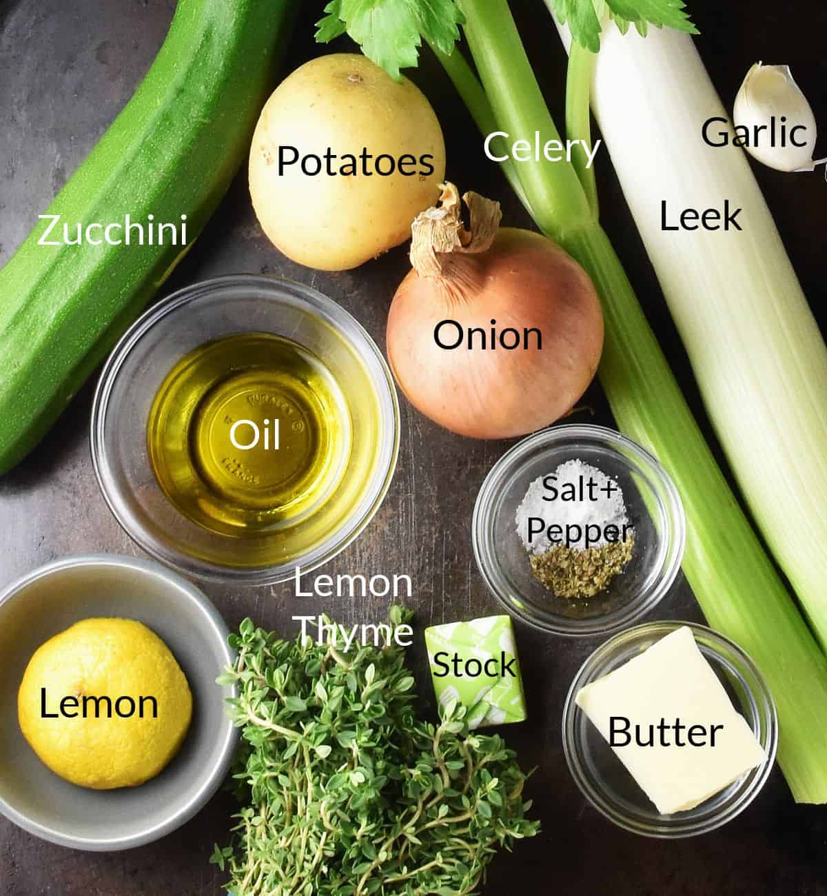 Top down view of ingredients for making zucchini potato soup in small individual containers.