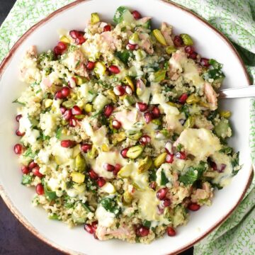 Top down view of quinoa salmon salad in white bowl.