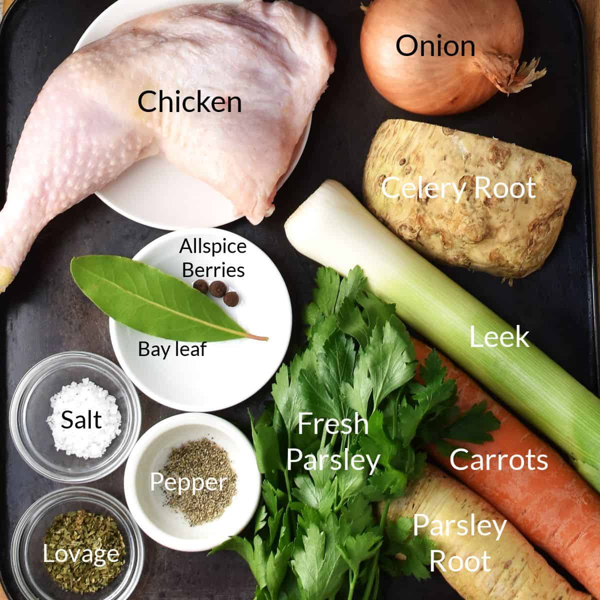 Top down view of ingredients for Polish chicken noodle soup in individual dishes on top of black surface.