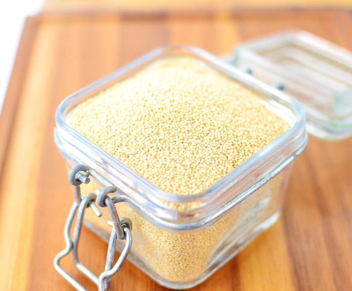 Raw amaranth seeds in open jar.