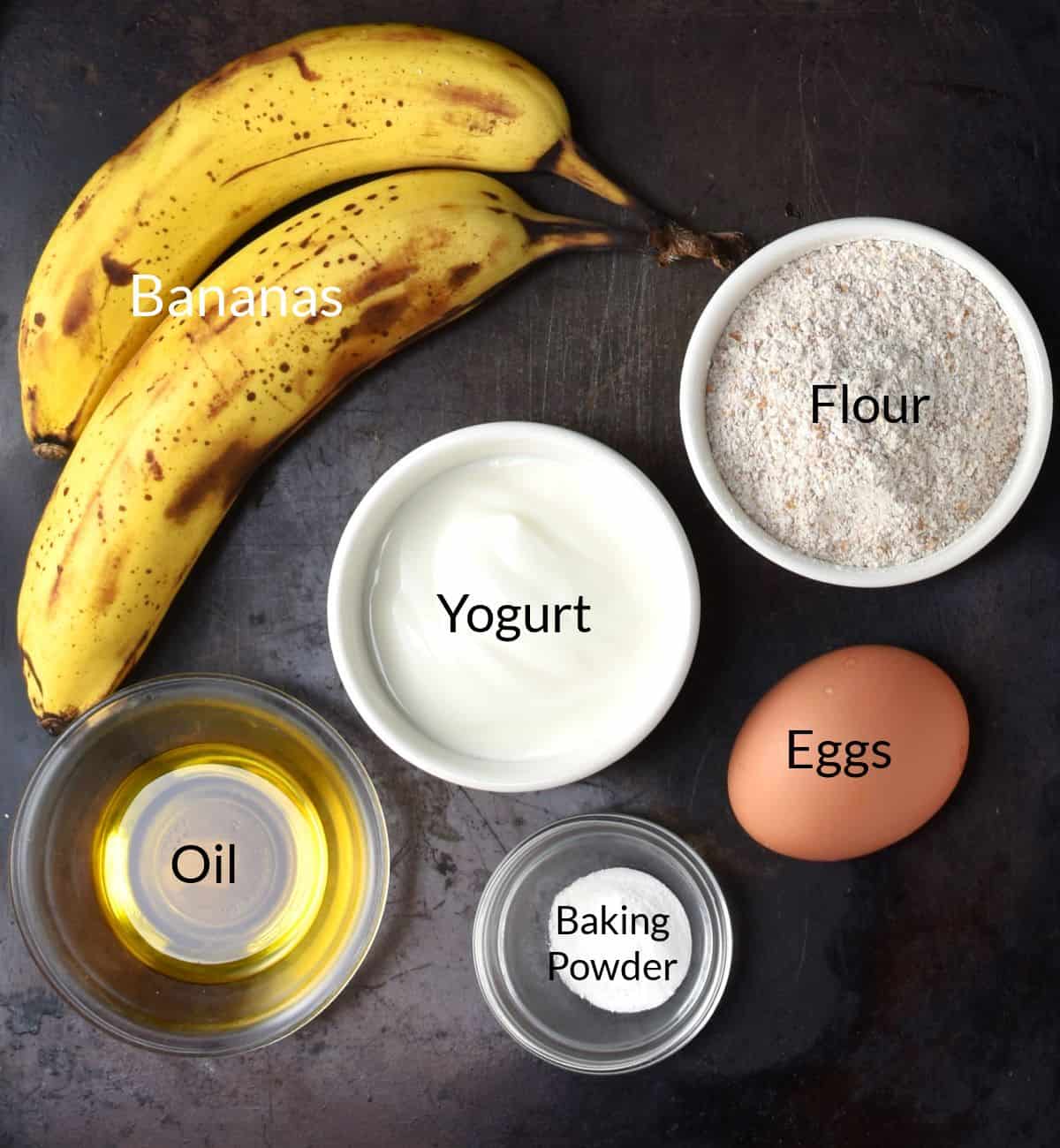 Ingredients for making banana yogurt pancakes in individual dishes.