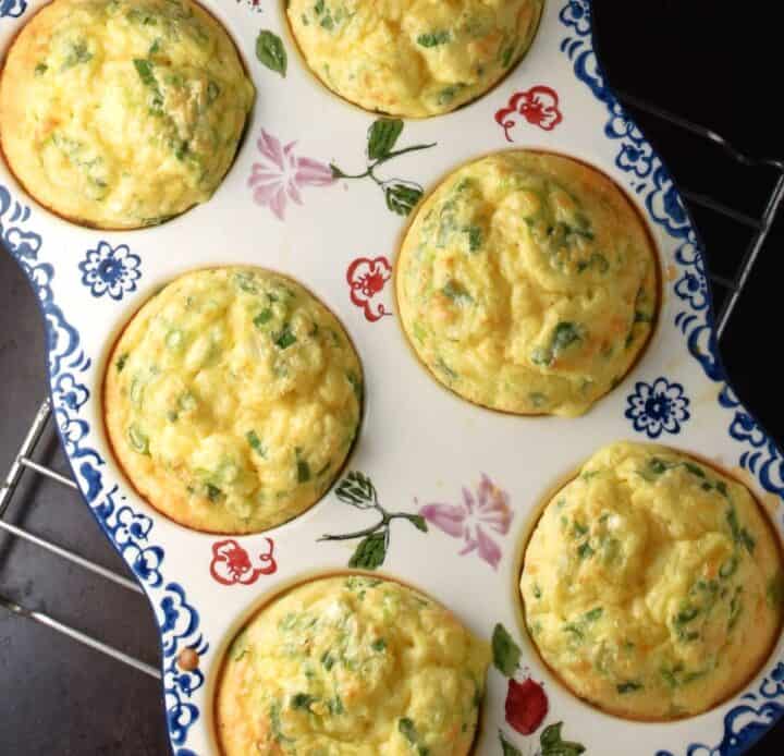 6 baked egg and quinoa muffins in ceramic pan.