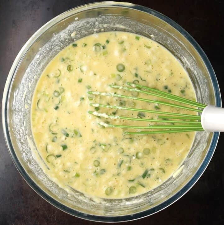 Quinoa egg muffin batter in mixing bowl with whisk.