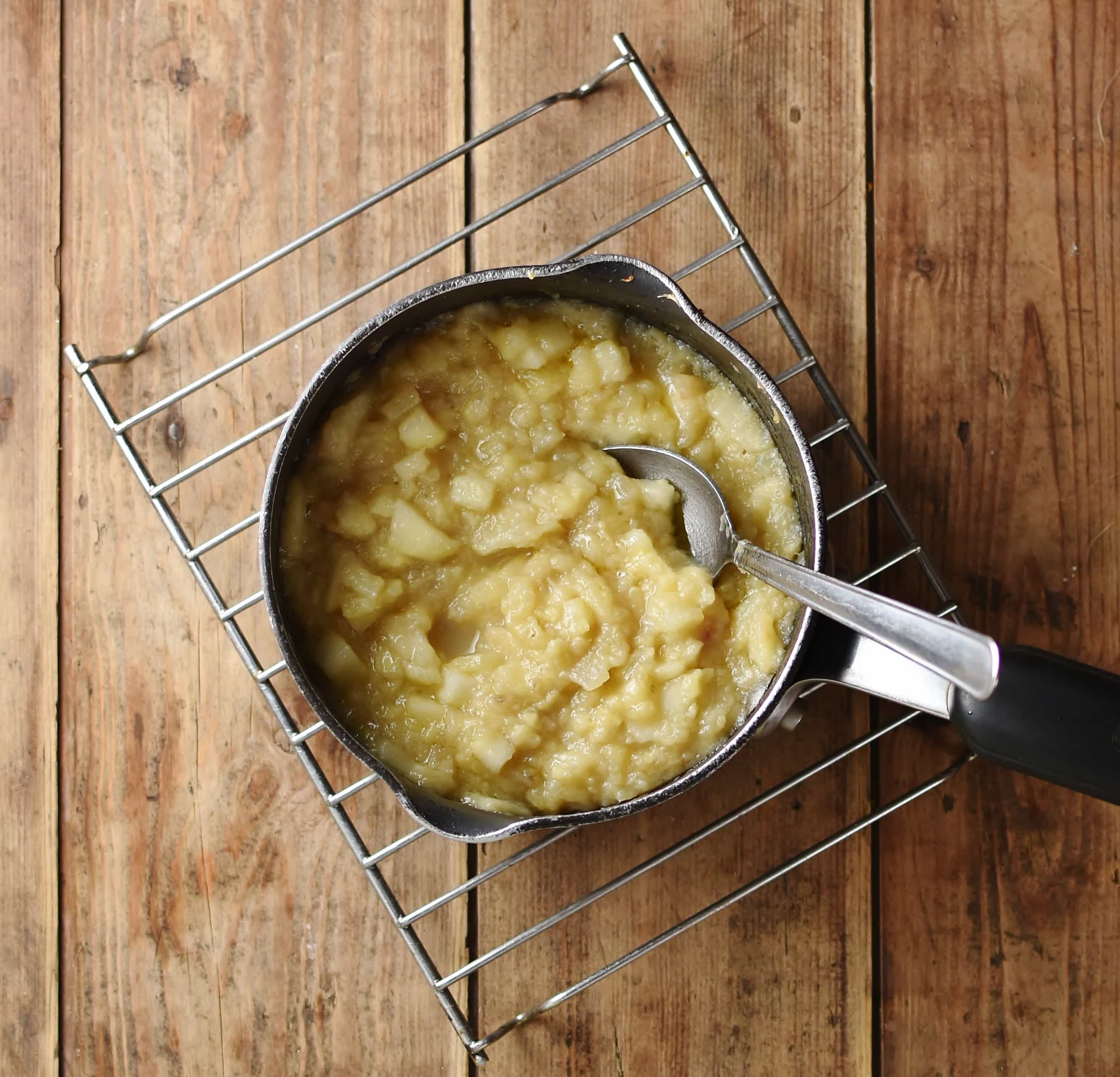 Banana mixture in small saucer with spoon on cooling rack.