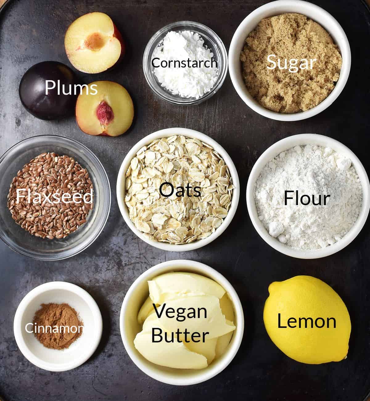 Ingredients for making vegan plum crumble in individual dishes.