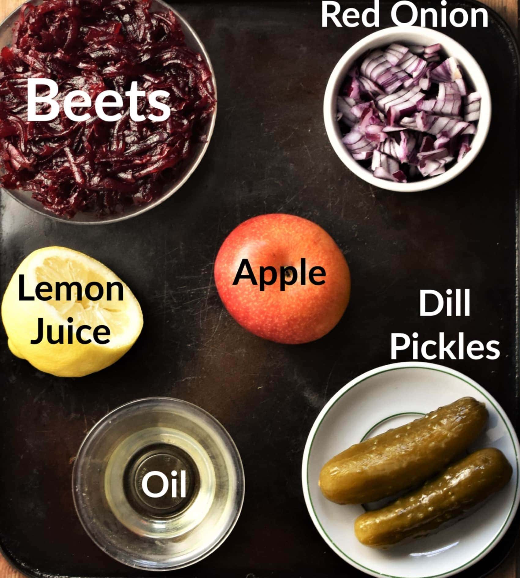 Cold beet salad ingredients in individual dishes.