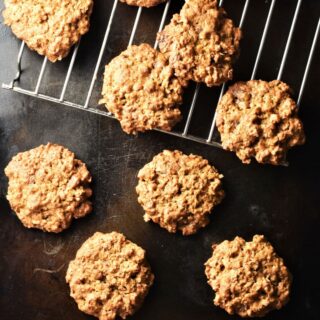 Healthy peanut butter oatmeal cookies on top of black tray and rack.