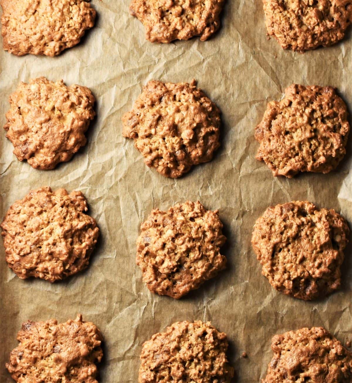 Peanut butter cookies on top of parchment.