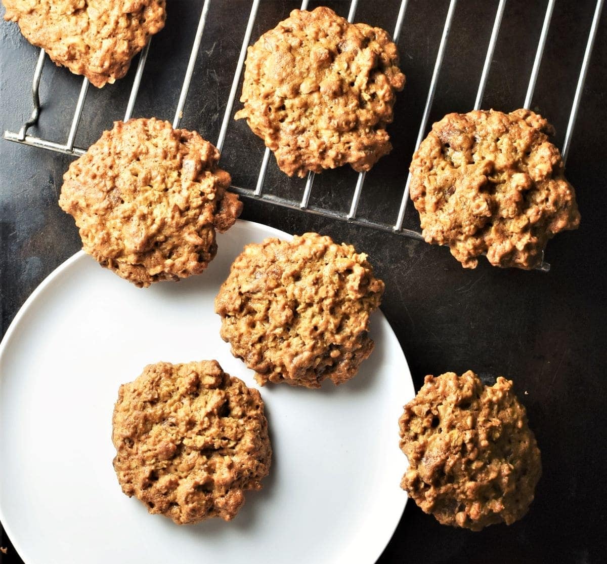 Peanut butter cookies on top of plate and rack.