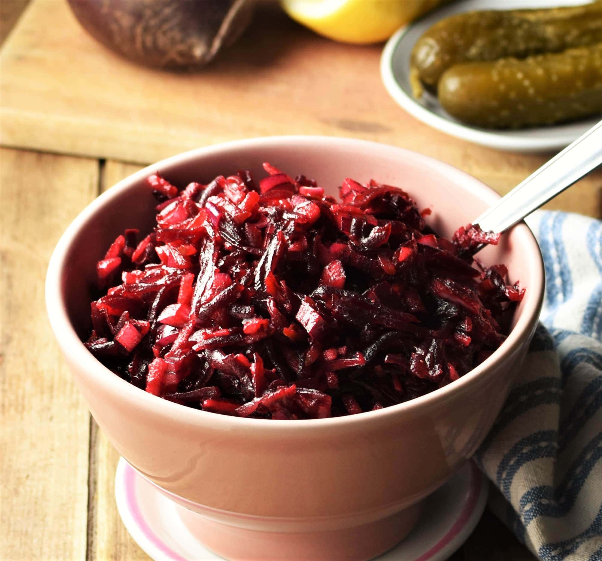 Close-up view of Polish beetroot slaw in pink bowl with spoon.