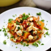 Tuna bake with butternut squash, spinach and feta on white plate.
