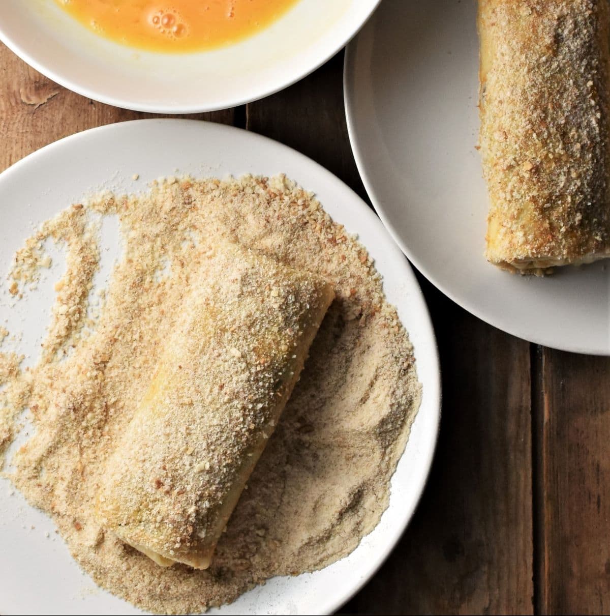 Coating krokiety crepes in egg wash and breadcrumbs.