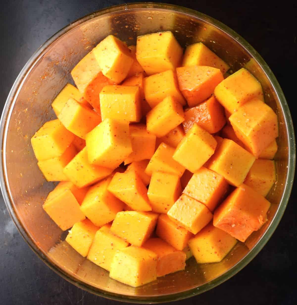 Cubed butternut squash in mixing bowl.