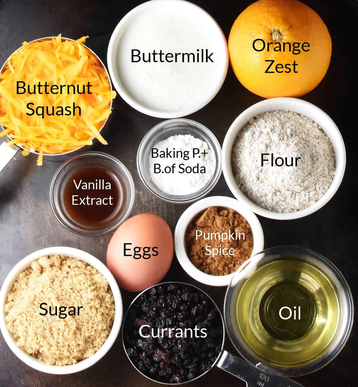 Top down view of butternut squash muffin ingredients in individual dishes with labels.