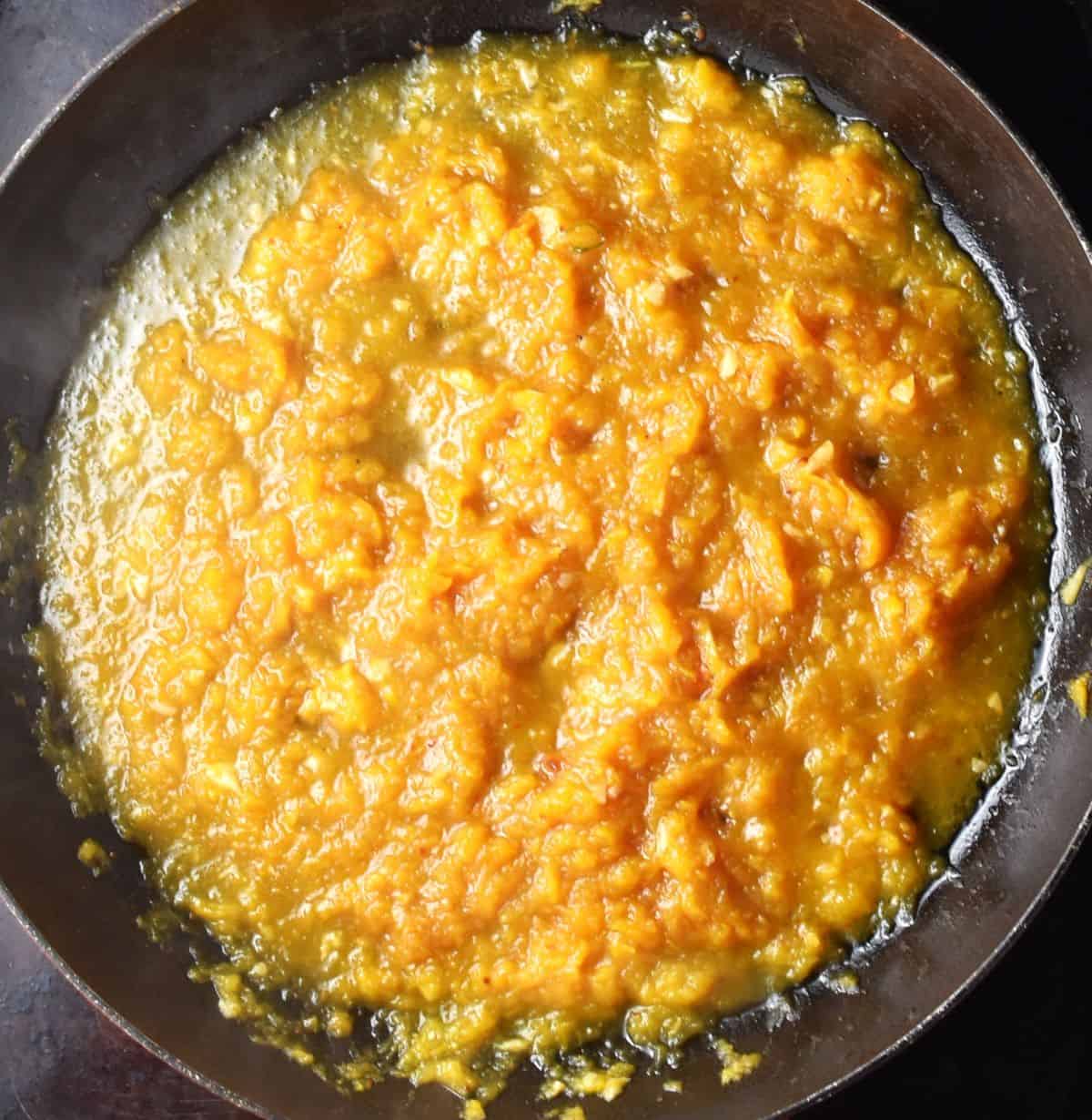 Making squash sauce in large pan.