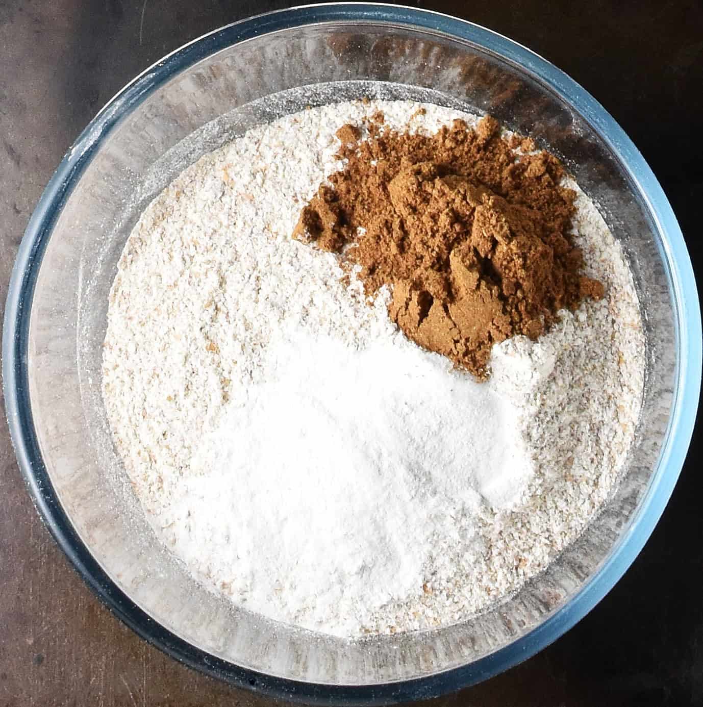 Top down view of dry ingredients for muffins in glass bowl.
