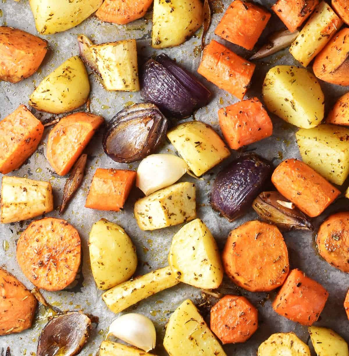 Pieces of roasted root veggies on top of parchment.