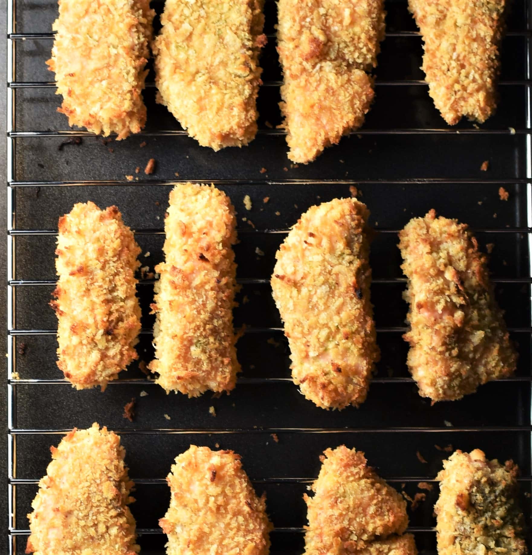 Crispy baked salmon fingers on top of rack.
