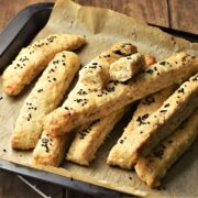 Side view of breadsticks on top of parchment.