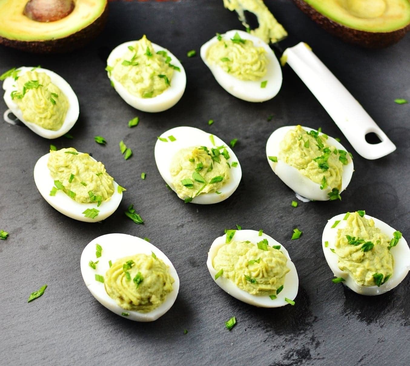 Deviled eggs on top of slate surface.