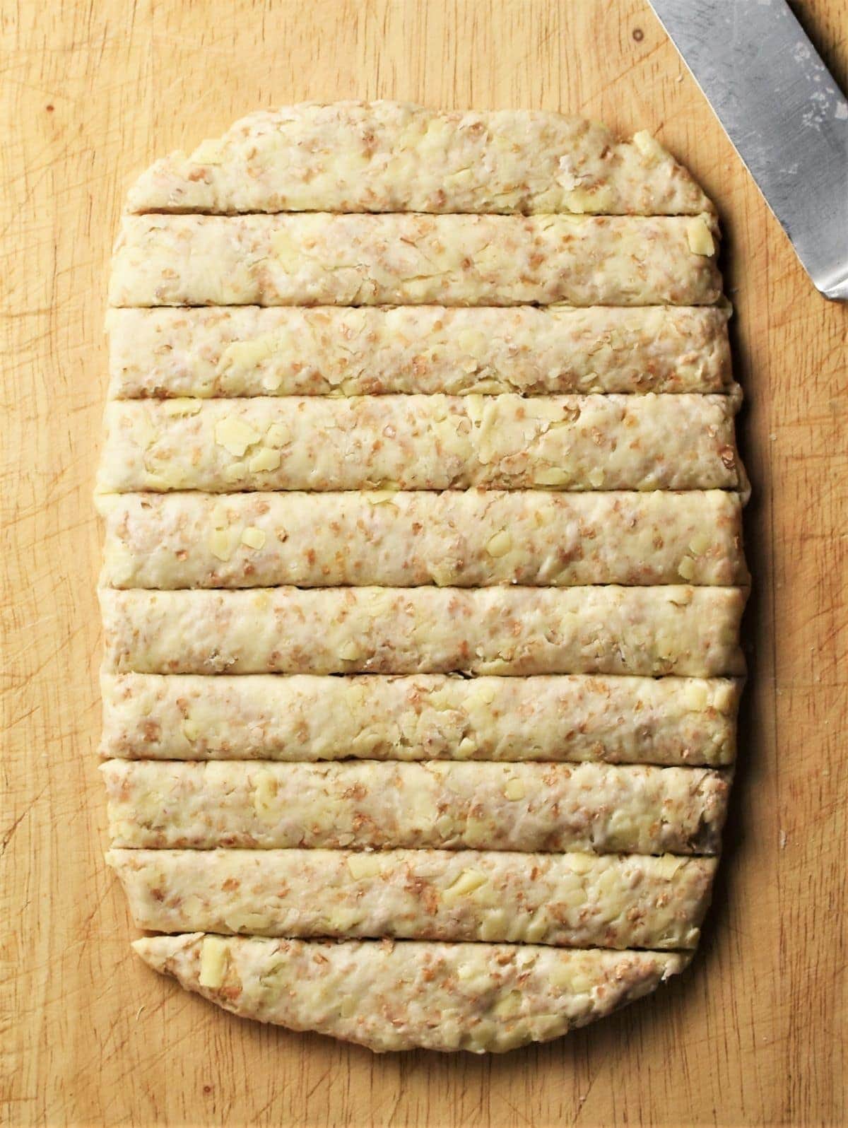 Rectangle dough cut into breadsticks.