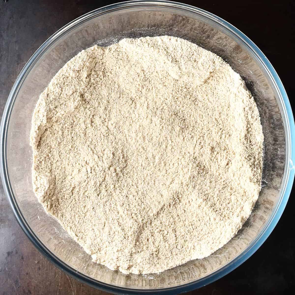 Dry mixture for gf apple muffins in glass bowl.