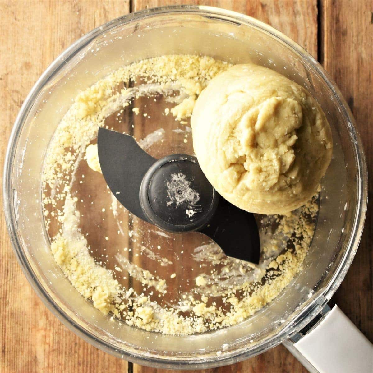 Crescent cookies dough in food processor bowl.
