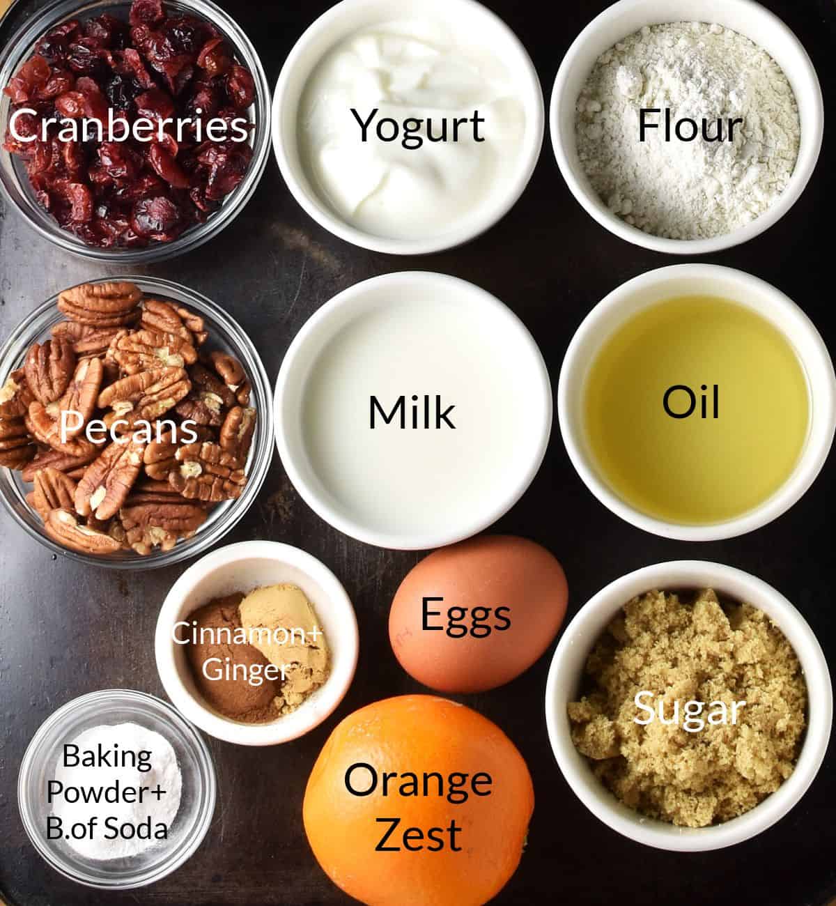 Top down view of dried cranberry muffin ingredients in individual dishes.