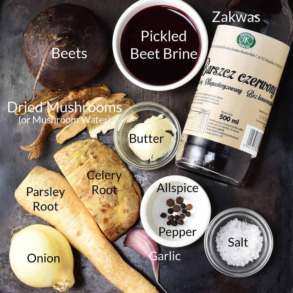 Top down view of barszcz soup ingredients in individual dishes and bottle on top of metal surface.