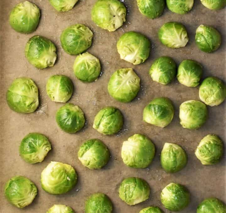 Halved brussels sprouts on top of parchment.