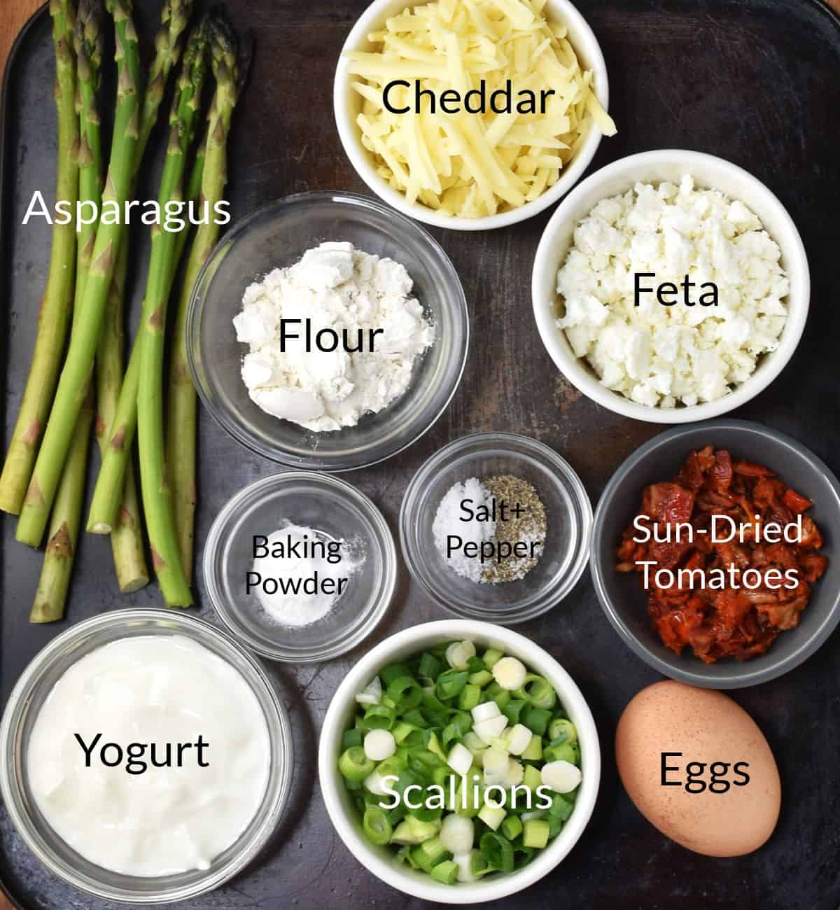 Ingredients for making asparagus muffins in individual dishes.
