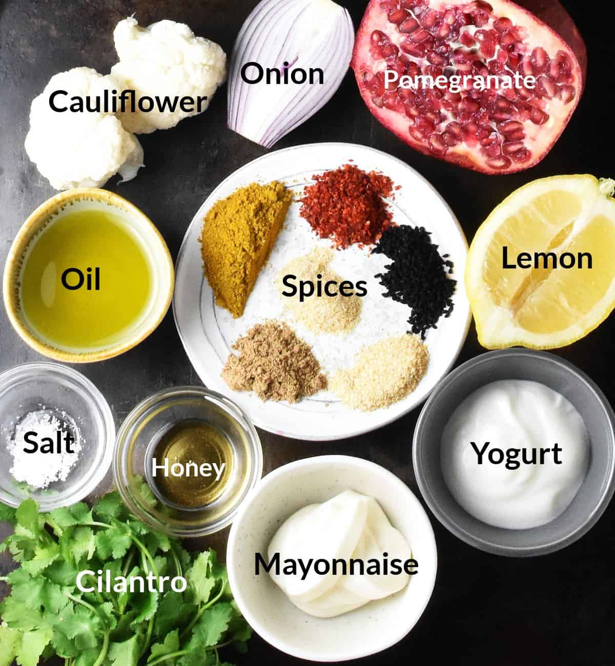 Top down view of ingredients used in curried cauliflower salad in individual dishes.