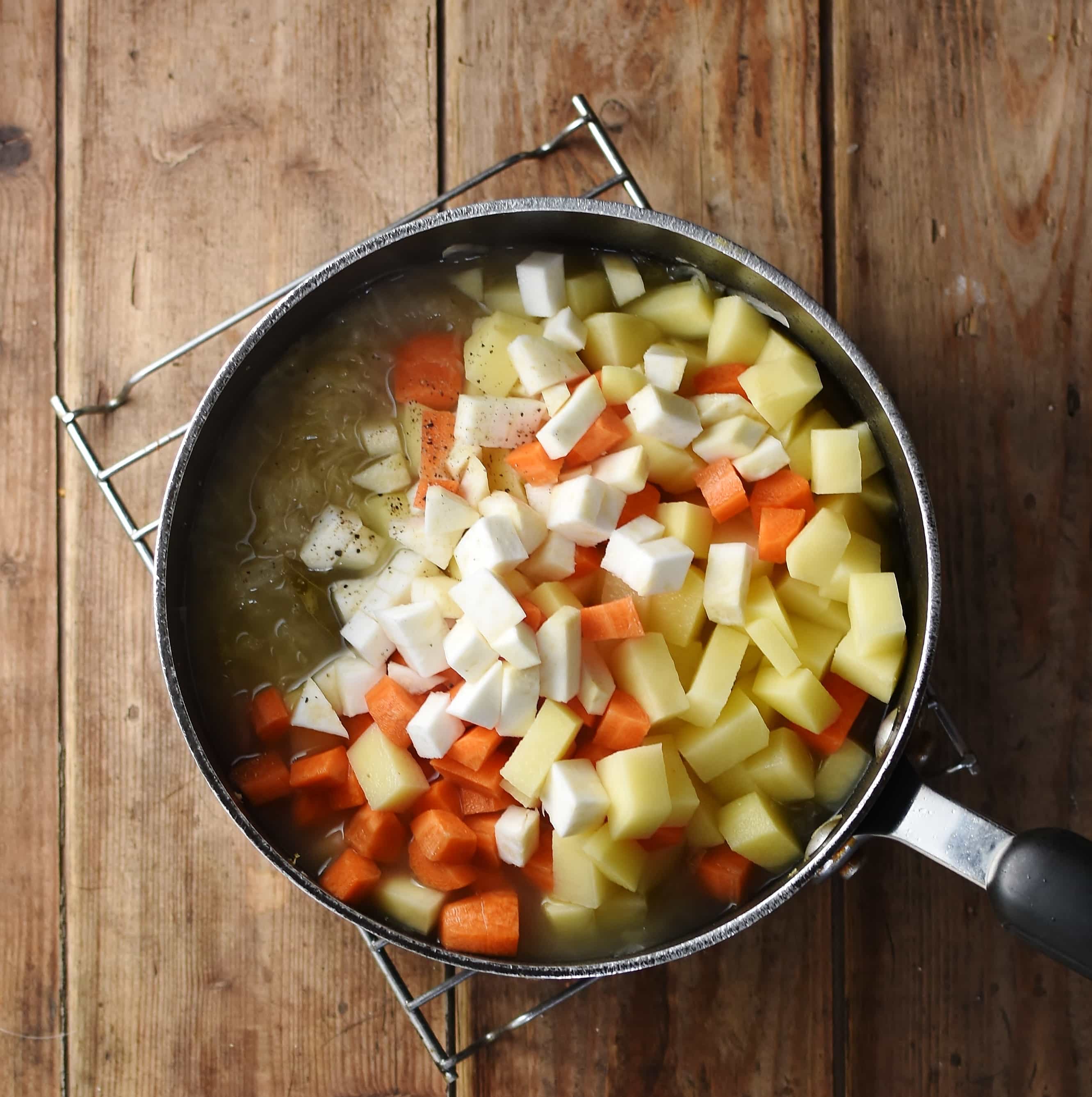 Cubed carrots, potatoes and celeriac in large pot.