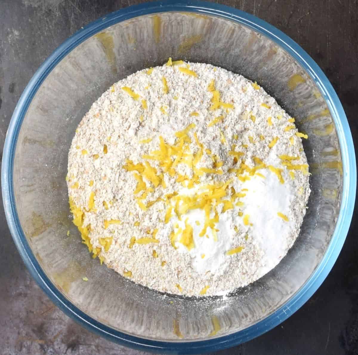 Top down view of dry ingredients for chia pancakes in glass bowl.