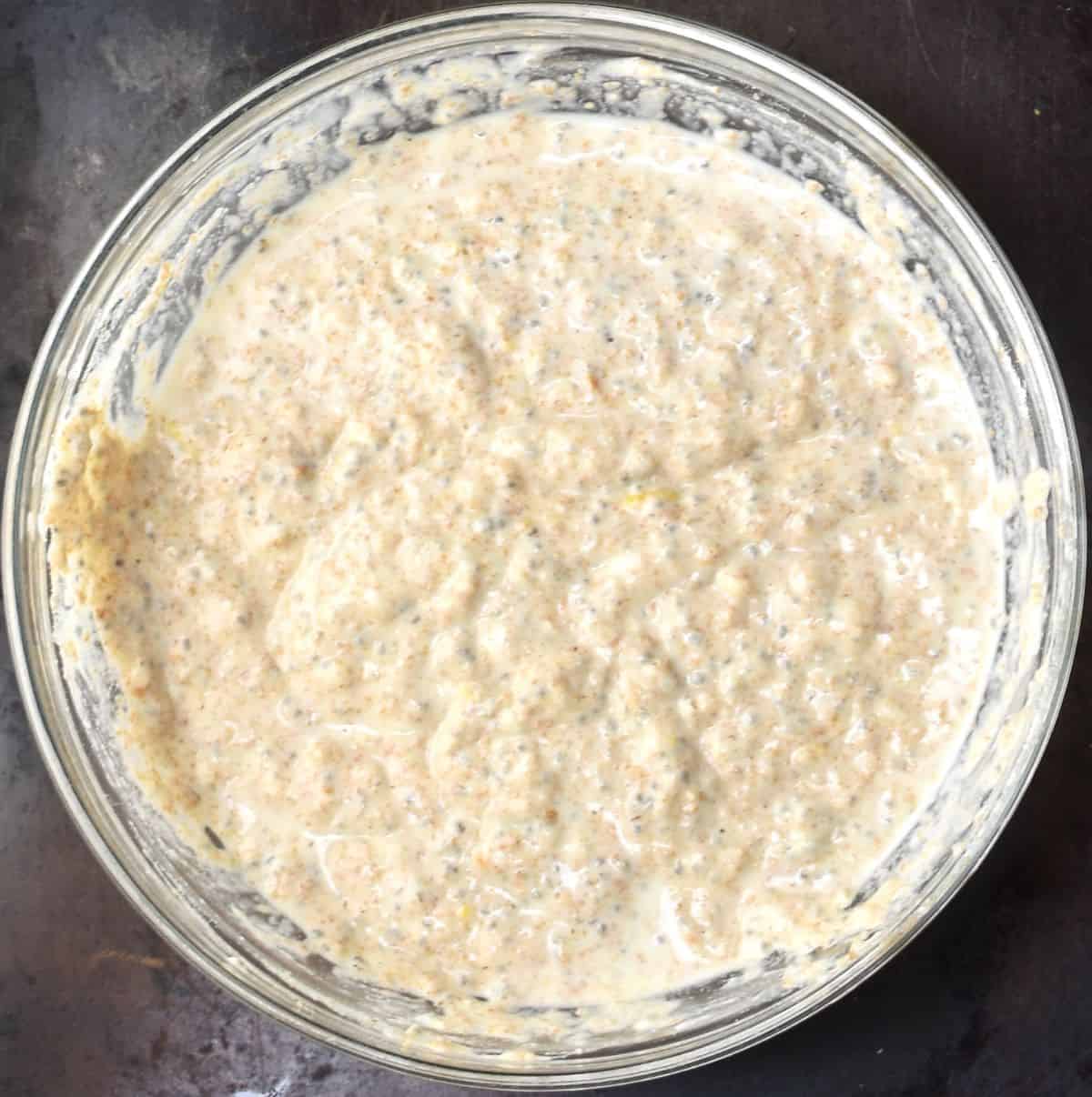 Thick chia pancake batter in glass bowl.