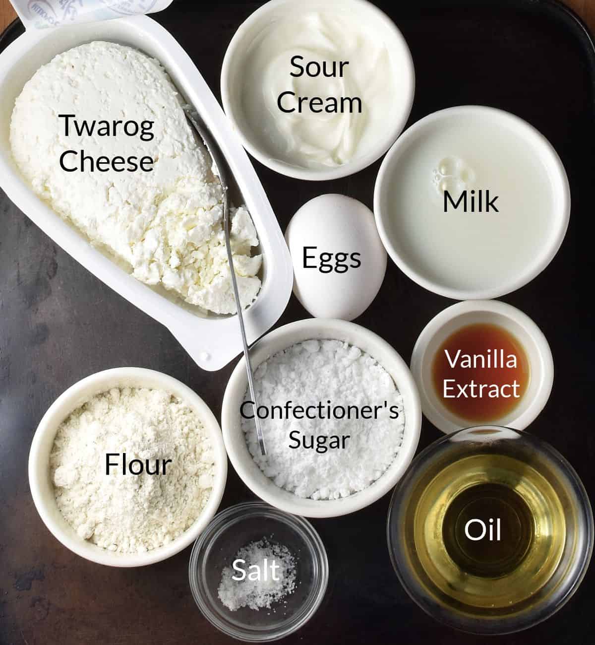 Top down view of Polish crepes ingredients close together in individual dishes.