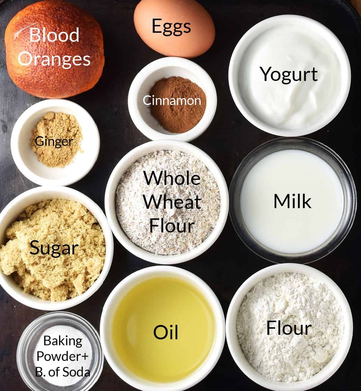 Top down view of ingredients for making blood orange muffins in individual dishes.