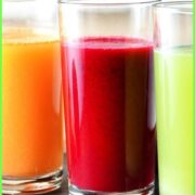 Cabbage juice in three glasses, green, red and orange.
