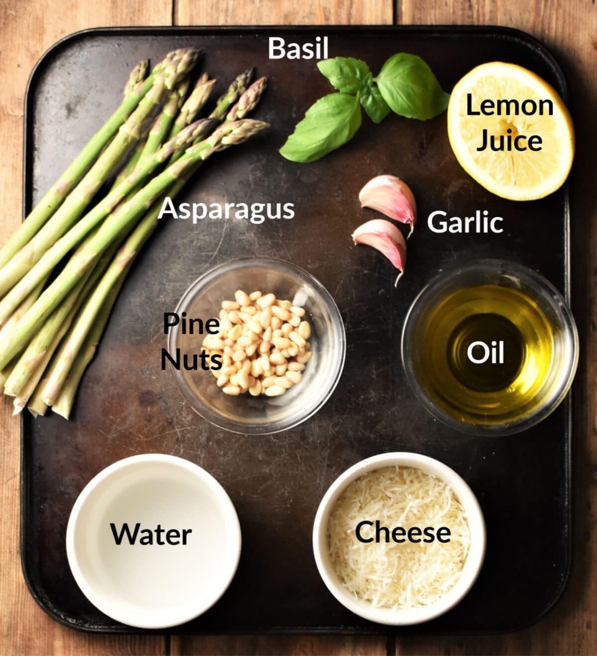 Asparagus pesto pasta ingredients in individual dishes.