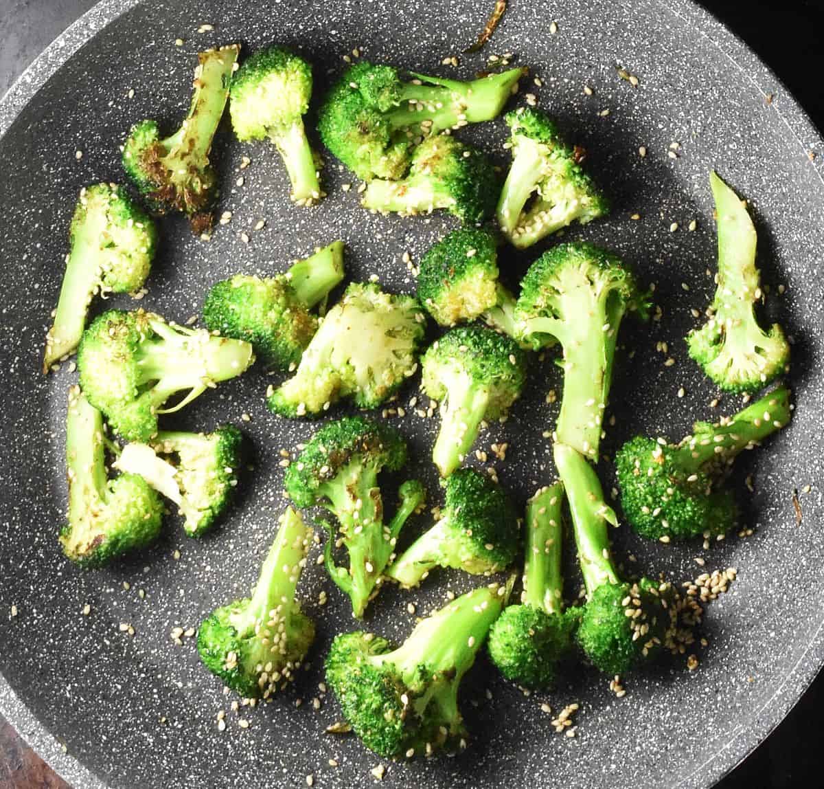 Top down view of broccoli florets in large pan.