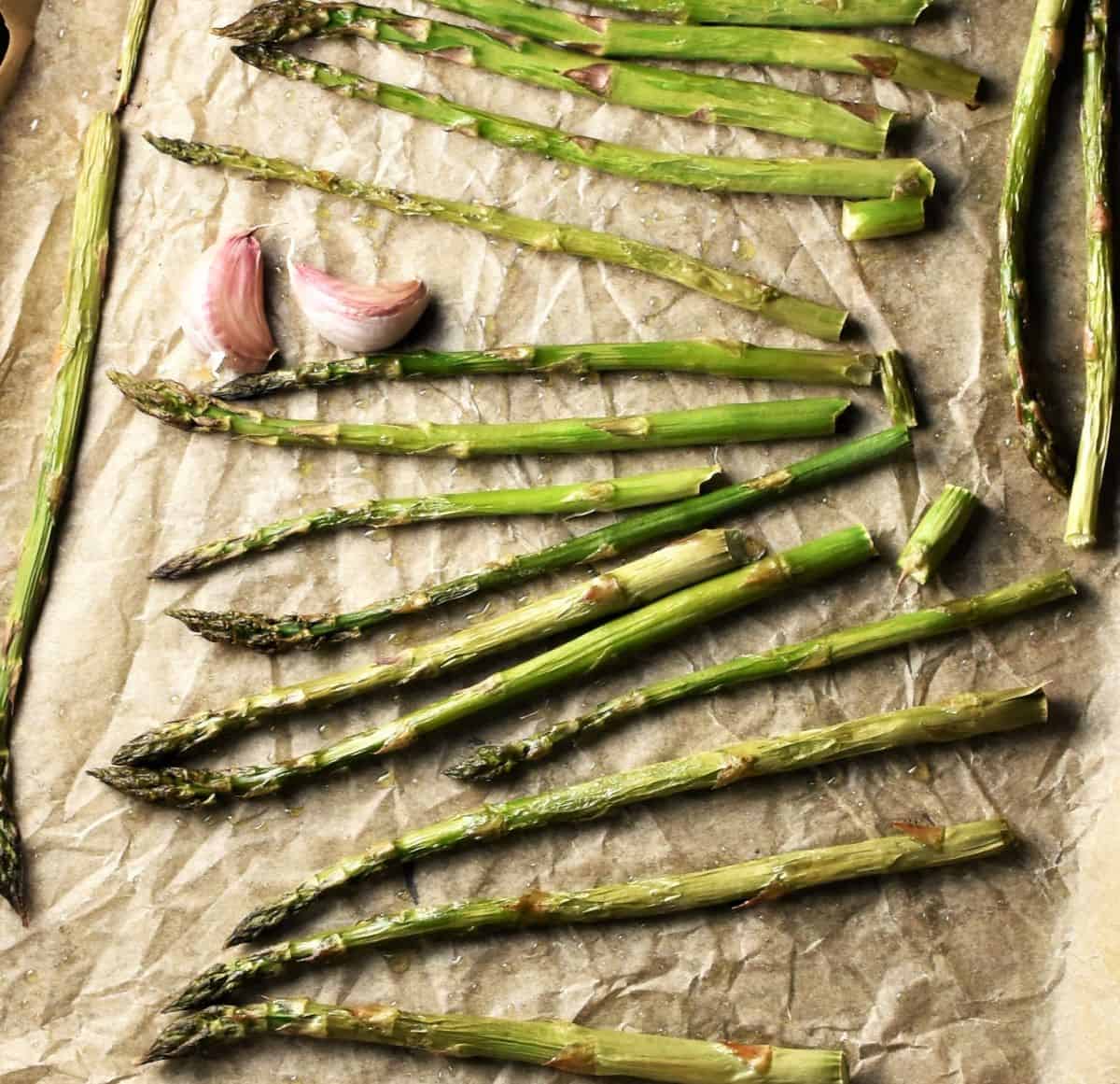 Roasted asparagus with garlic on parchment.