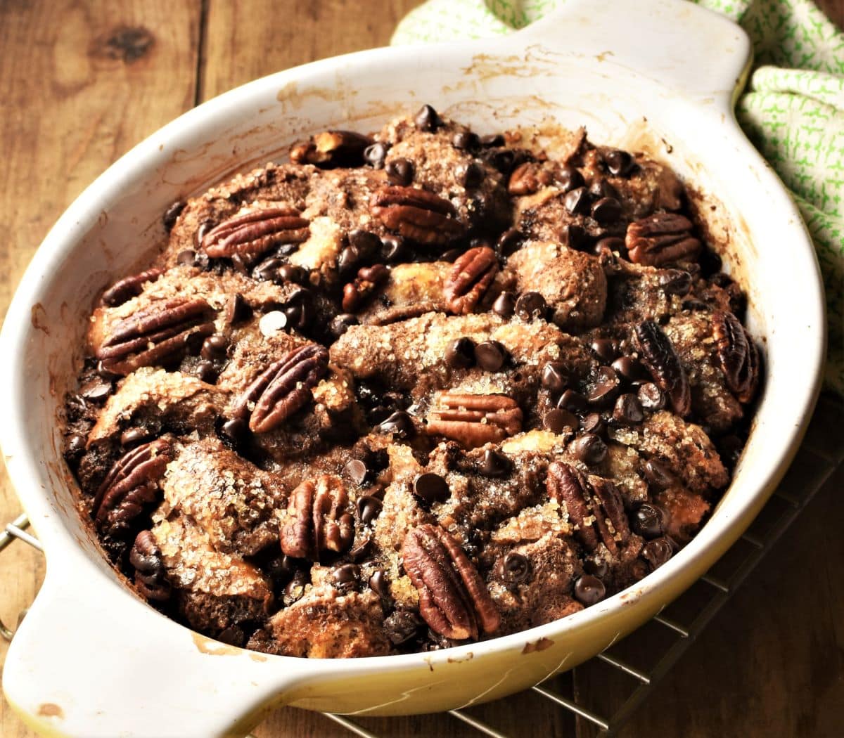 Side view of french toast bake with chocolate chips in white dish.